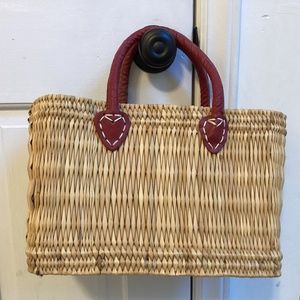 Straw purse with red leather handles